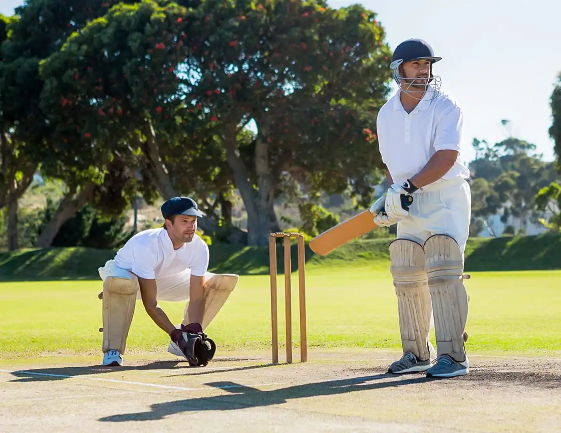 A group of men playing cricket on a team.