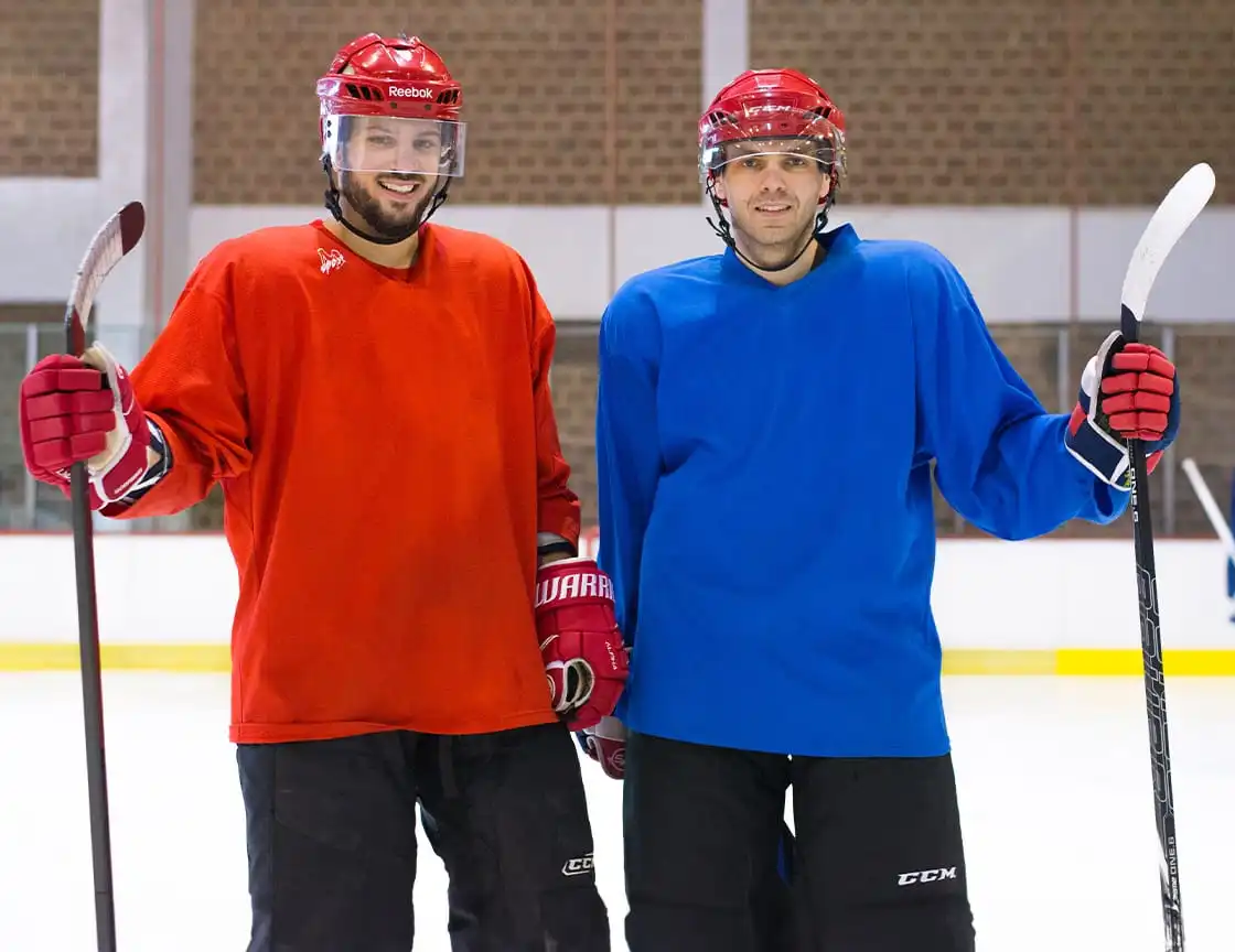 A group of men playing hockey on a team.