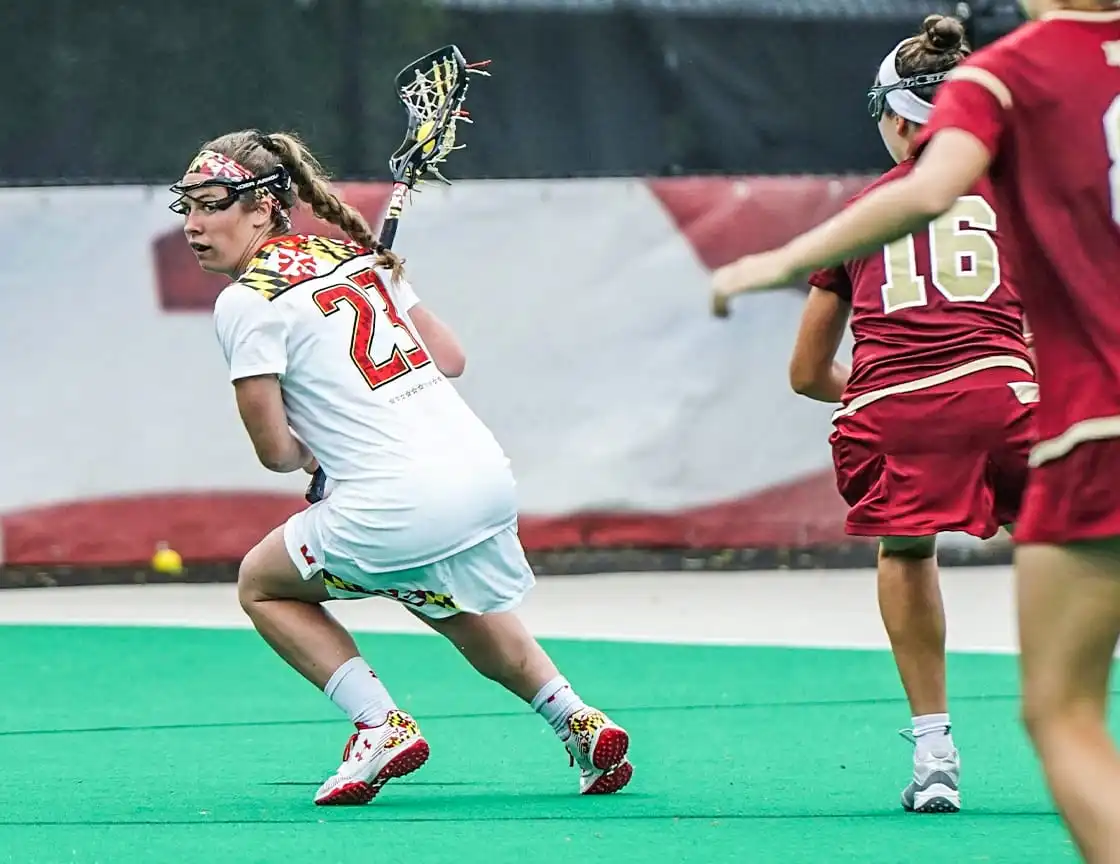 A group of women playing lacrosse on a team.